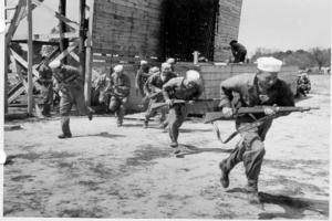 Seabee boots bolt from a mock LCVP at Camp Peary