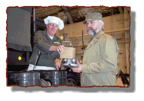 The cook serves an enlisted soldier a "C" ration