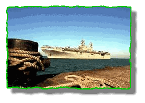 The amphibious assault ship USS Tarawa (LHA 1) approaches a pier in Mina, Bahrain, for a port call. US Navy photo by JO2 Charles Neff.